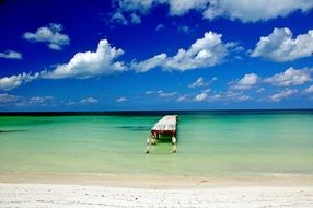 lonely boat on the beach near blue water