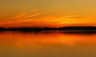 red sunset sky above calm water