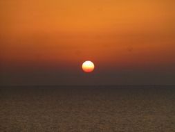 orange sunset over the sea on the horizon