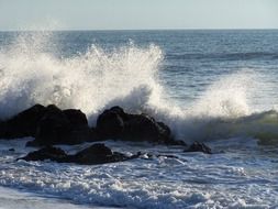 waves hit the rocks on the island