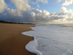 foamy surf in the sand