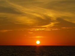 Setting sun on a sky above the ocean