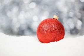 red Christmas ball at blur grey background