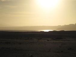 black and white photo of ocean coastline at the sunlight