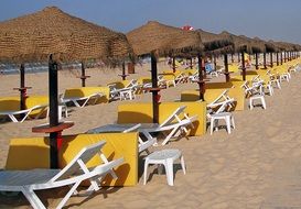 umbrellas and sun beds on a sunny beach in Portugal