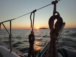 ropes on a sailing ship at sunset