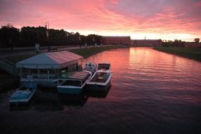 Boats near the shore on a sunset background