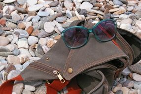 photo bag and sunglasses on a beach
