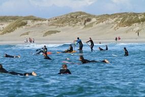 surfers catch a wave in the ocean