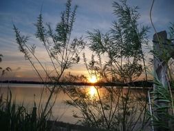 romantic sunset over the pond in the countryside