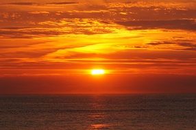 orange sunset in the clouds over the north sea