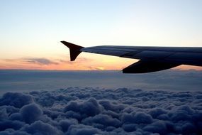 wing of the aircraft above the dense clouds