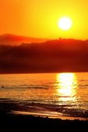 bright yellow setting sun over the mountains