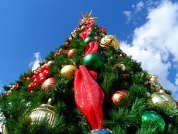 huge christmas tree against the blue sky