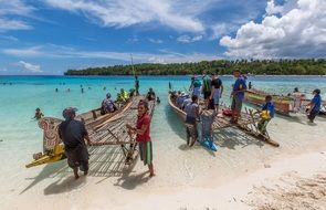 people with canoe on the beach in Papua New Guinea