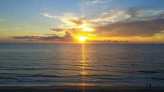 distant view of a bright sunrise over the ocean