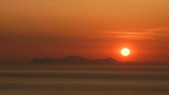 distant view of a romantic sunset over greece