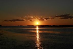 bright sun at sunset on the sea in Orbetello