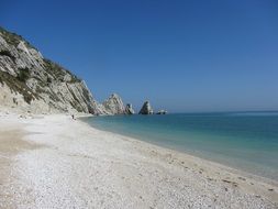 empty beach at rocky coast, italy, monte conero