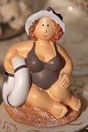 statue of adult fat woman on sand