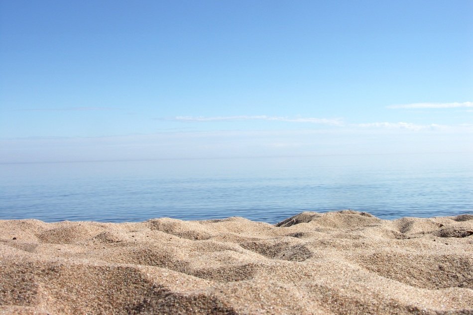 Landscape of Yellow Sand beach and beautiful water with sunshine on it