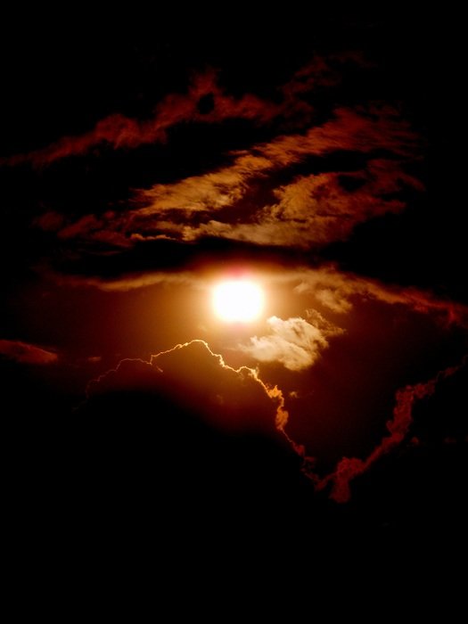 Sun at sunset through the clouds