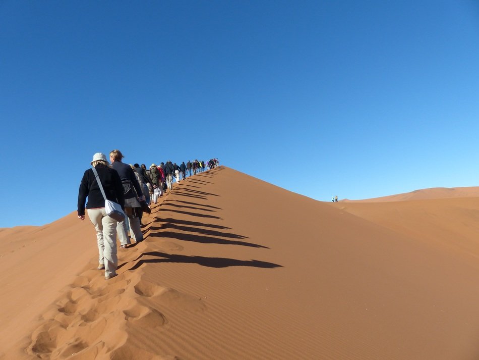 Tourists walking on sand dunes, namibia, Sossusvlei