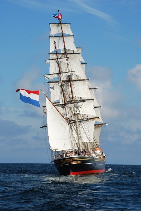 ship at sea with the flag of amsterdam