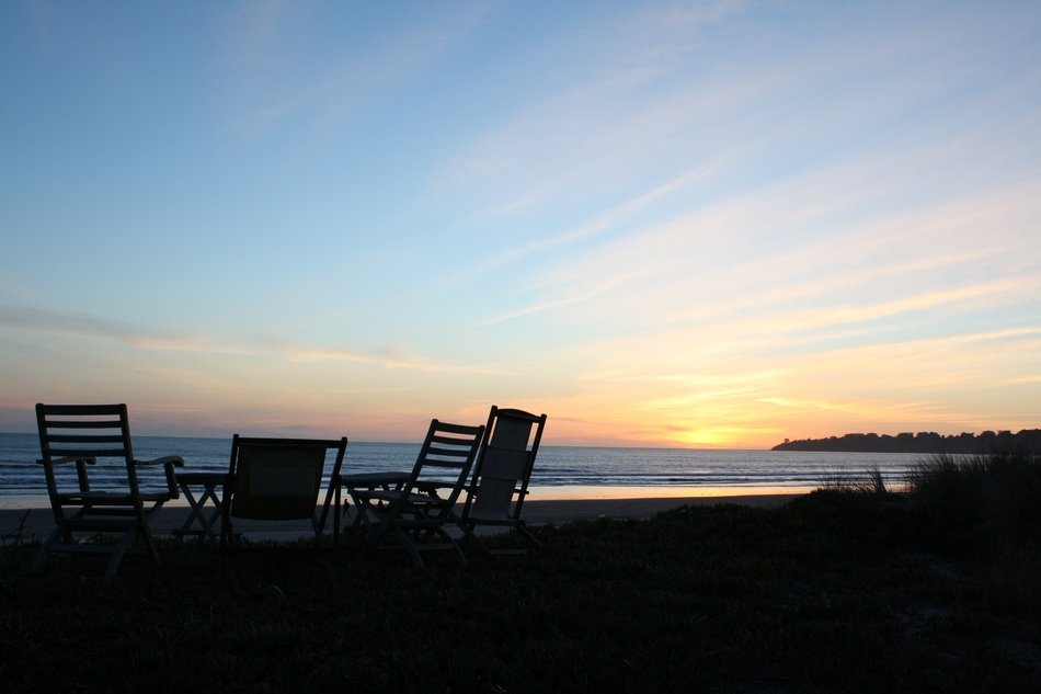 Chairs on the beach under the sunset