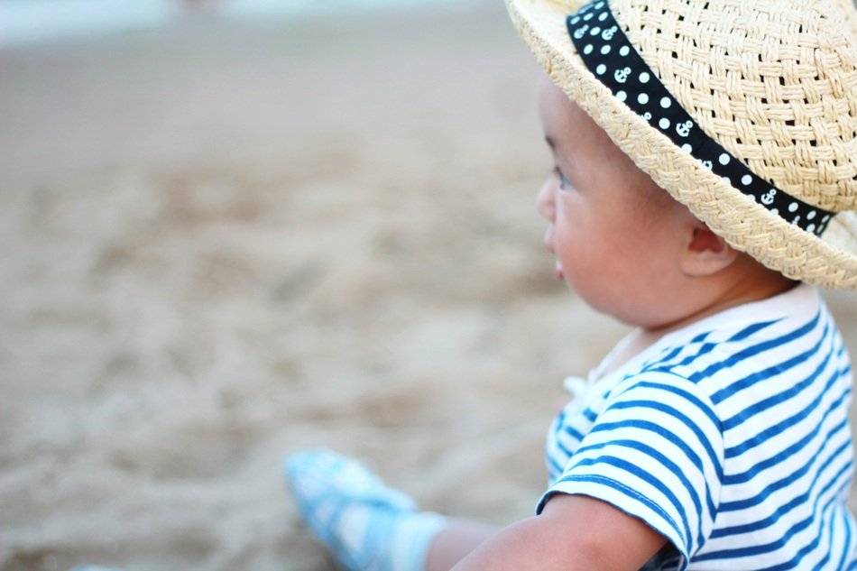 happy kid in the hat on the beach