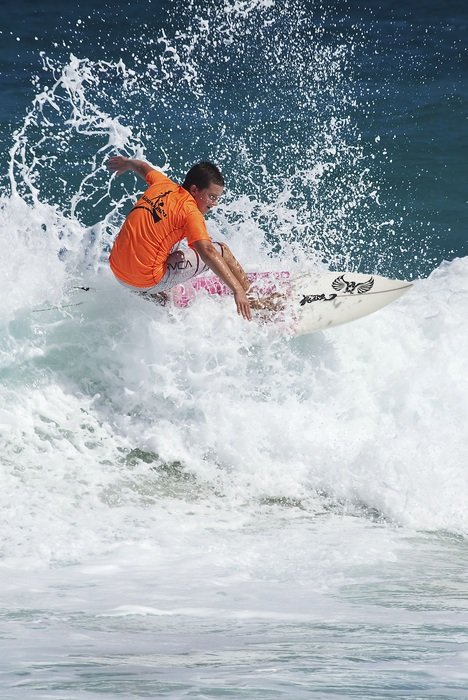 Surfer balances on the wave