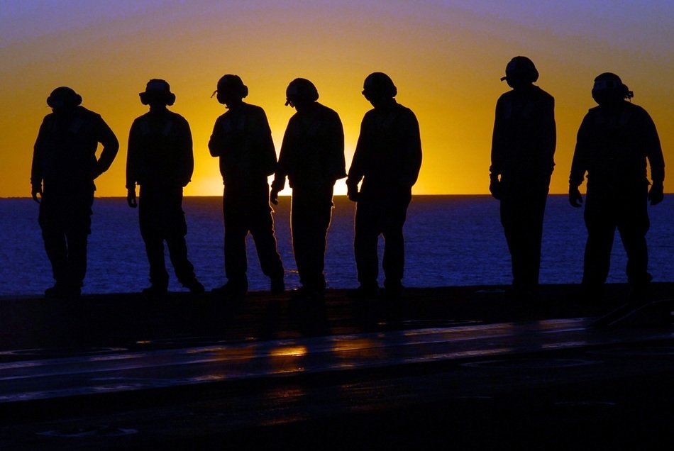 dark silhouettes of crew on deck