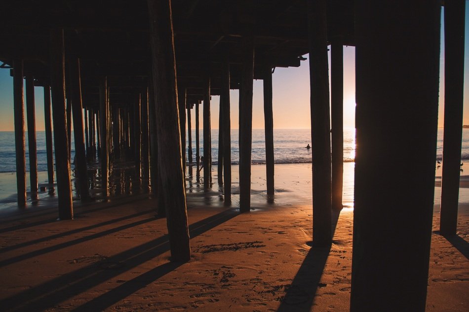 sand under the wooden pier