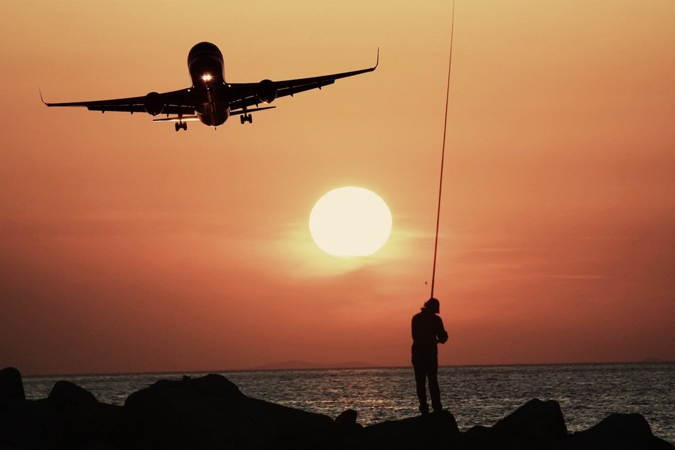 aircraft over the coastline at sunset