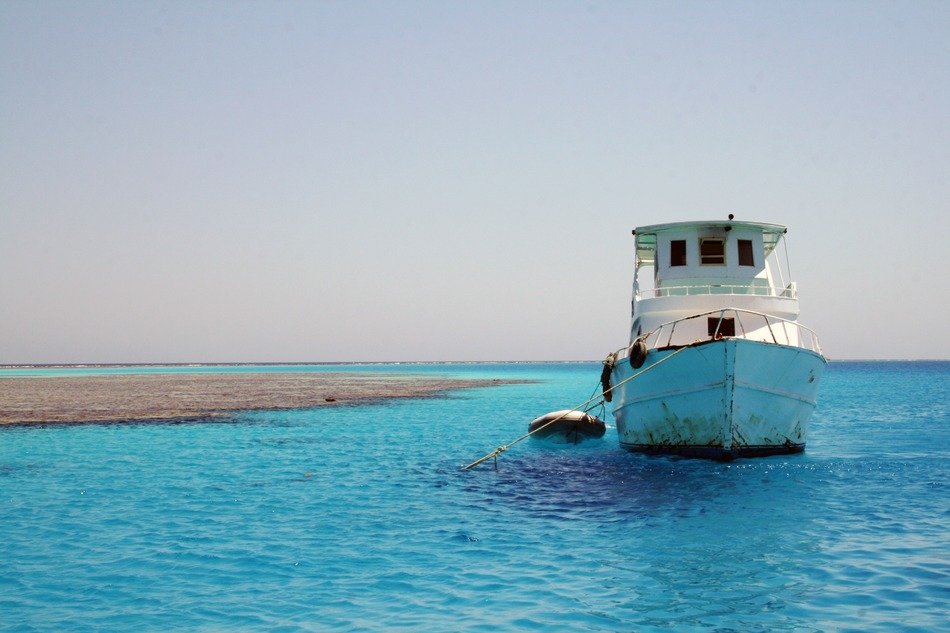 white fishing boat in the blue ocean