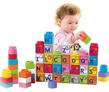 child puts cubes into the wall