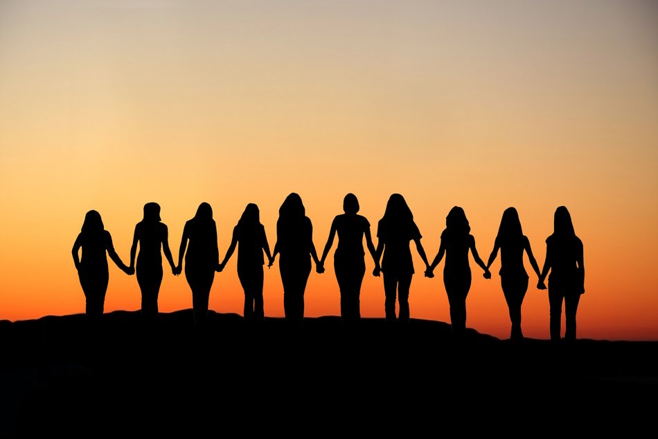Photo of group of women at the background of the sunset