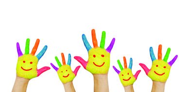 painted emoticons on the hands of children