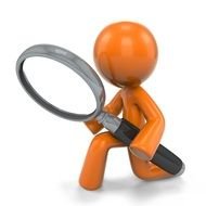figurine of a man with a magnifying glass in his hands