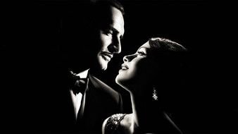 man in a tuxedo near the girl in the dark