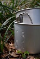 aluminum camping pot on land green grass