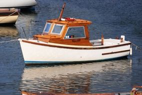 white and yellow fishing boat