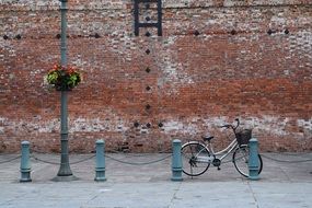 bycicle in front of brick red wall