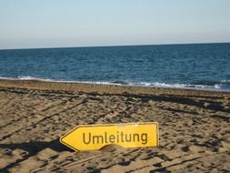 detour warning sign on the beach