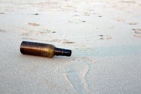 glass bottle on a sandy beach