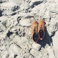 leather shoes on a sandy beach