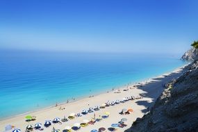 view from the mountain to the beach with umbrellas
