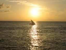 sailing boat at sunset sea, maldives