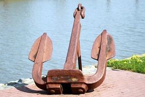 stainless steel anchor on the dock near the colorful plants