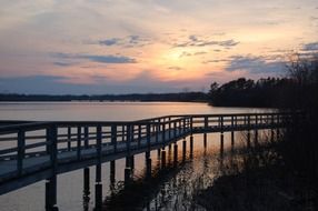 long boardwalk over the lake at dusk